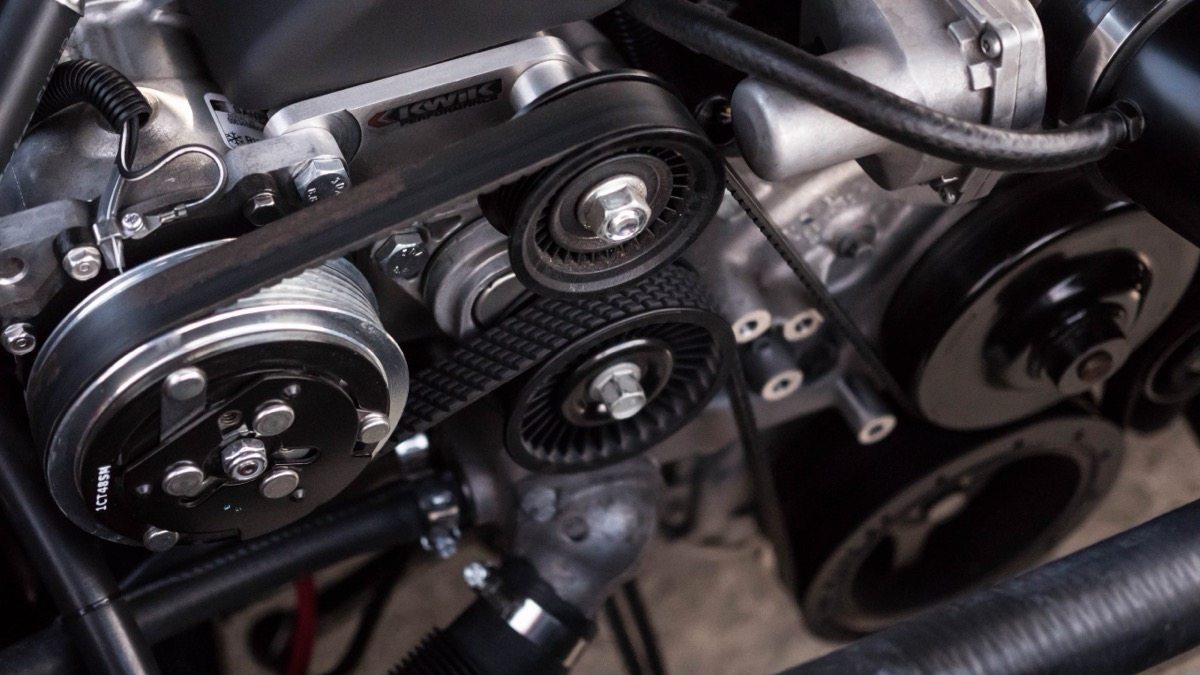 Close-up of an engine belt and pulley during servicing