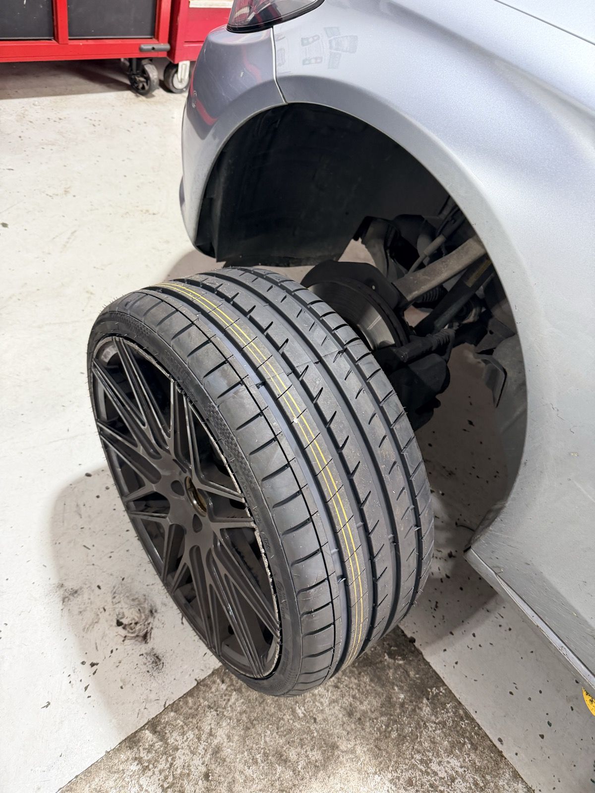 Wheel and tyre off the car during alignment work