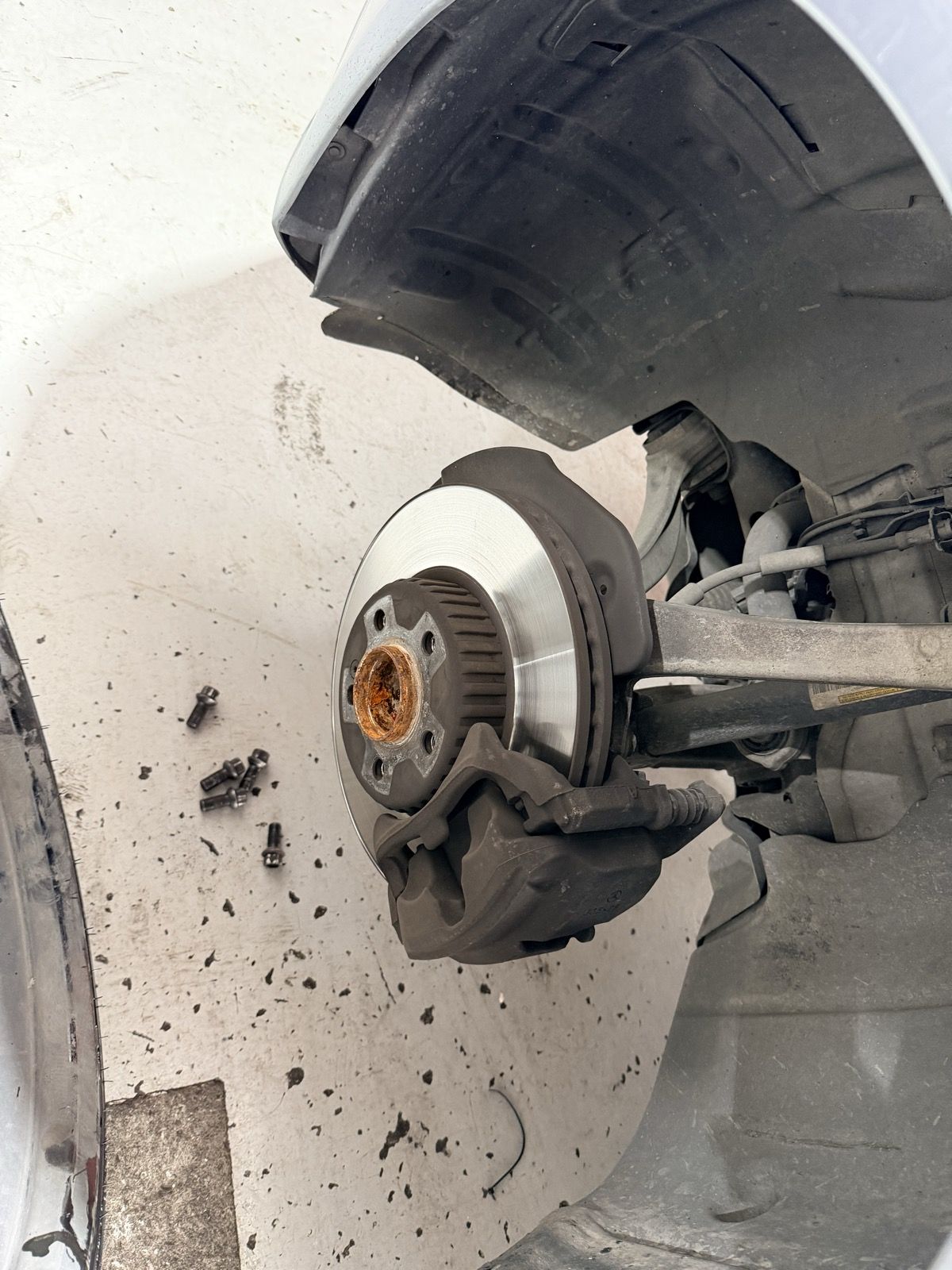 Brake rotor and caliper exposed during a brake service
